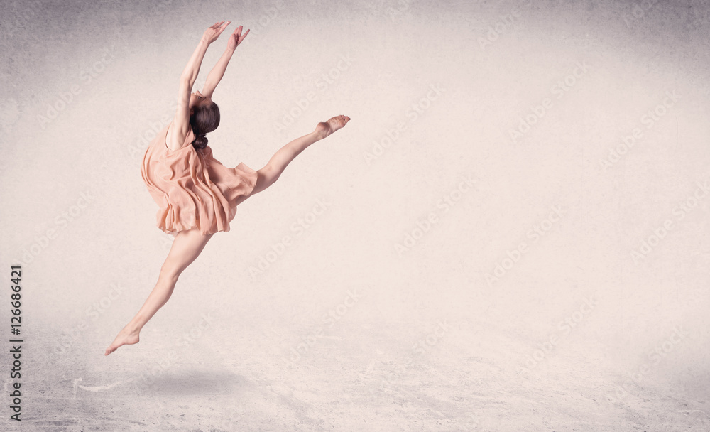 Fototapeta premium Modern ballet dancer performing art jump with empty background
