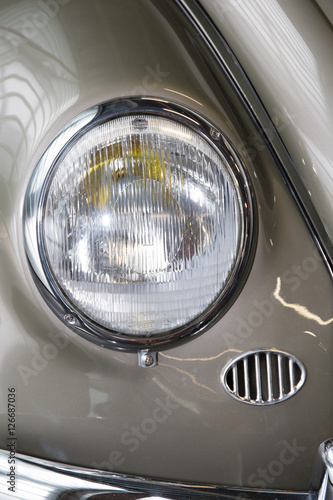 Close-up of front right side of a grey vintage car © OceanProd