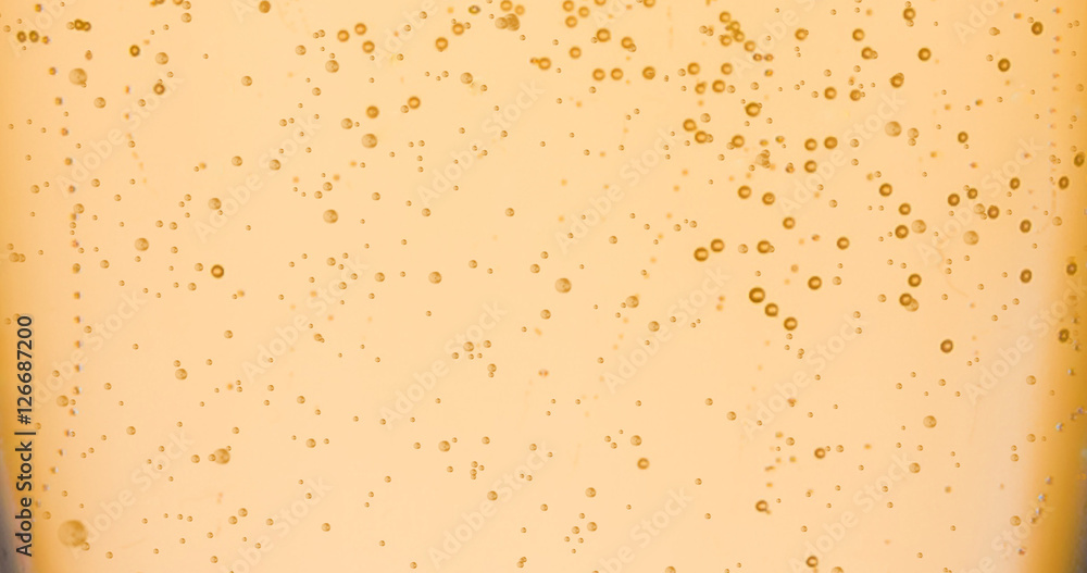 champagne golden bubbles inside a flute, gold background effect champagne golden bubbles inside a flute, gold background effect