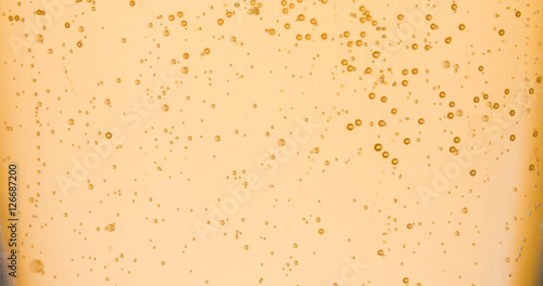 champagne golden bubbles inside a flute, gold background effect