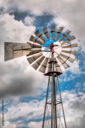Vertical Windmill Top Against Clouds