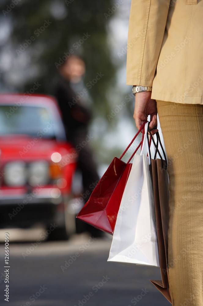 Woman carrying shopping bags, cropped image