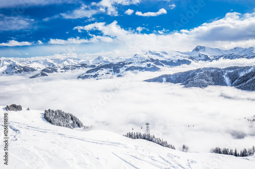 Trees and mountains covered by fresh snow in Kitzbühel ski resort, Tyrolian Alps, Austria photo