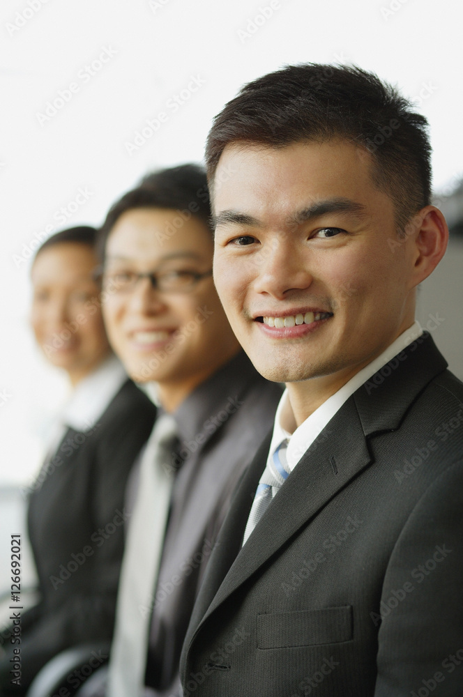 Executives in a row, focus on the businessman in foreground Executives in a row, focus on the businessman in foreground