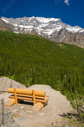 Picnic bench with gorgeous view at snow mountain in Canada. photo