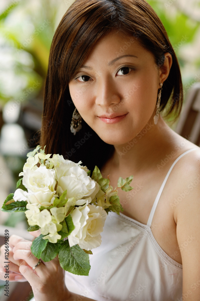 Young woman holding a bouquet of flowers, portrait Young woman holding a bouquet of flowers, portrait