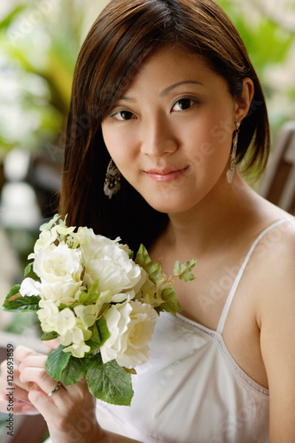 Young woman holding a bouquet of flowers, portrait