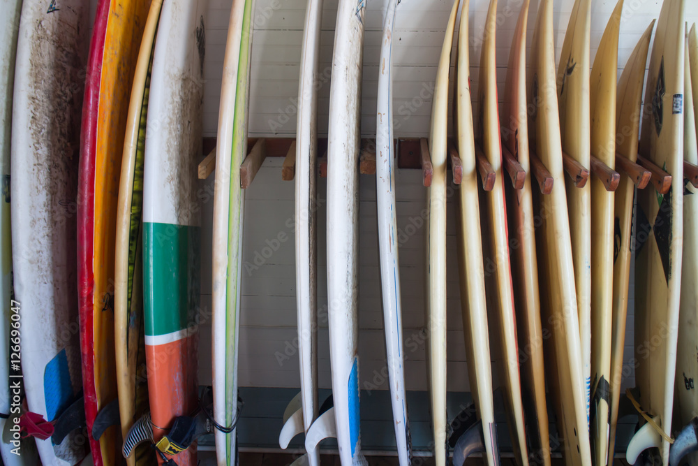 Set of different color surf boards in a stack