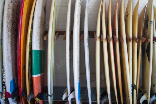 Set of different color surf boards in a stack