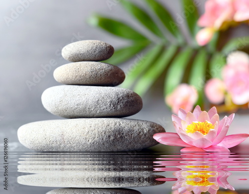 stones balance with flower lily on grey background