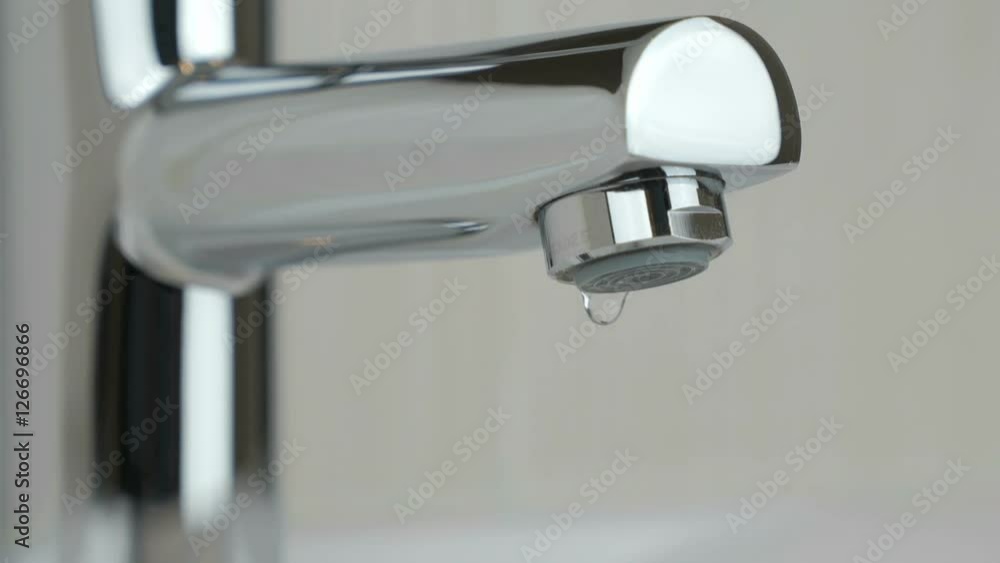 Drops of water seep through the water faucet Drops of water seep through the water faucet