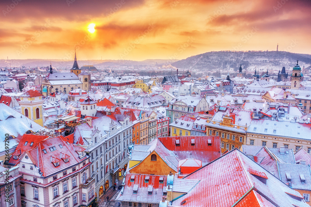 Obraz premium Prague in Christmas time, classical view on snowy roofs in central part of city.