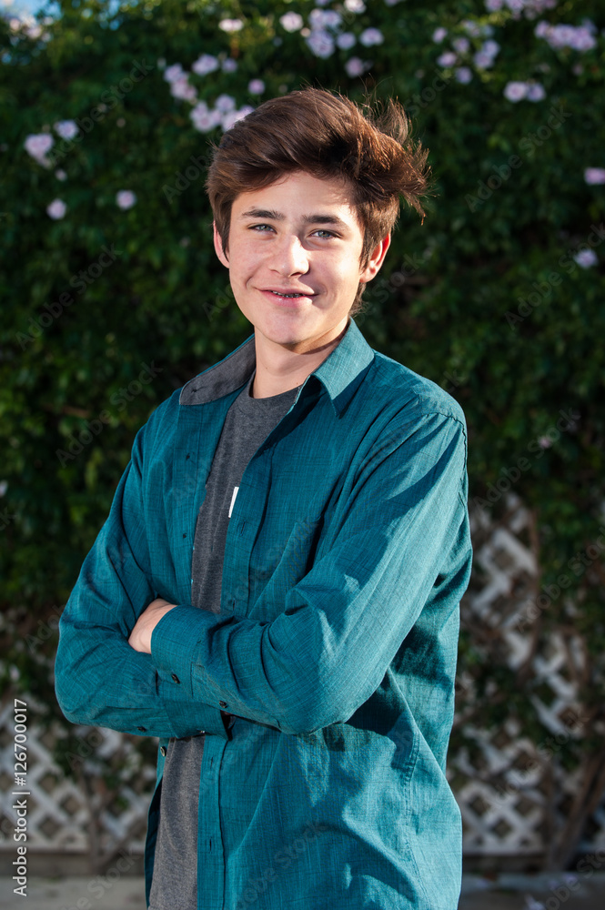 Handsome Latino teen smiling with arms crossed. Handsome Latino teen smiling with arms crossed.