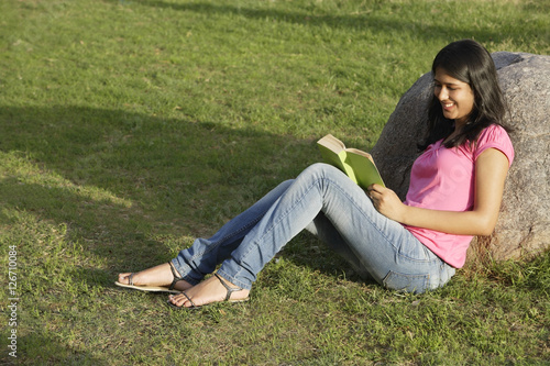 teen girl reading book in park © Alexander