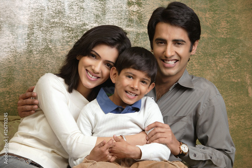 Photography family of three smiling at camera (horizontal)