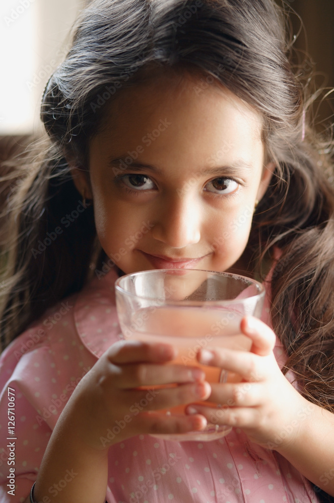 girl holding pink drink, looking at camera girl holding pink drink, looking at camera