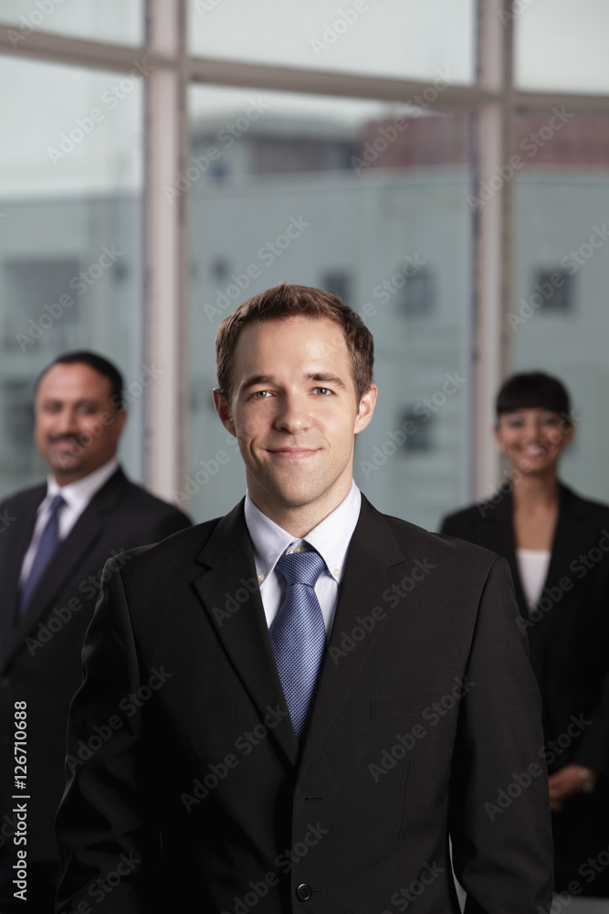 Caucasian man standing in front of his colleagues Caucasian man standing in front of his colleagues