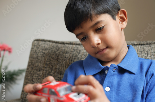 boy holding red car (horizontal)