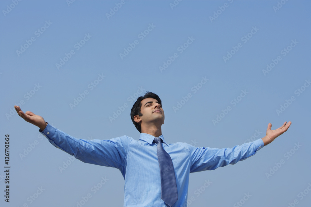 businessman with arms outstretched, eyes closed businessman with arms outstretched, eyes closed