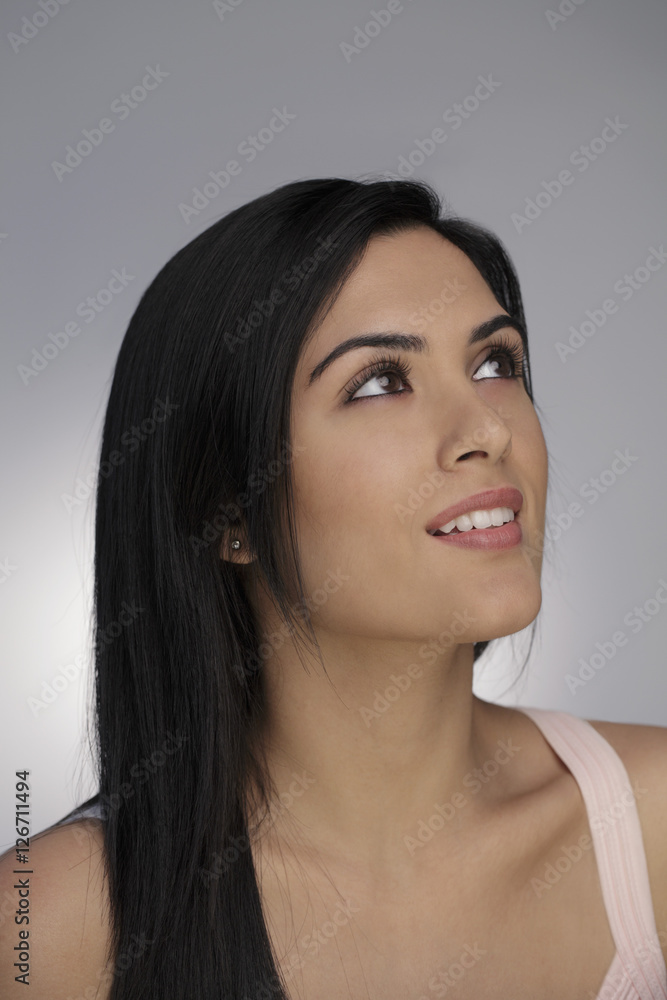 Head shot of young woman looking up Head shot of young woman looking up