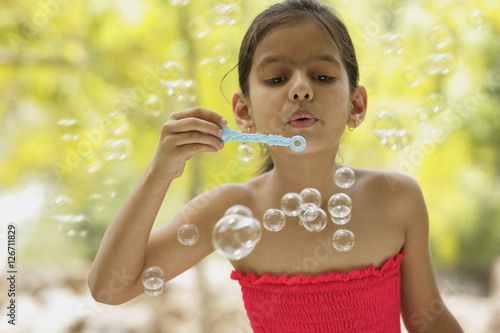 Photography little girl blowing bubbles