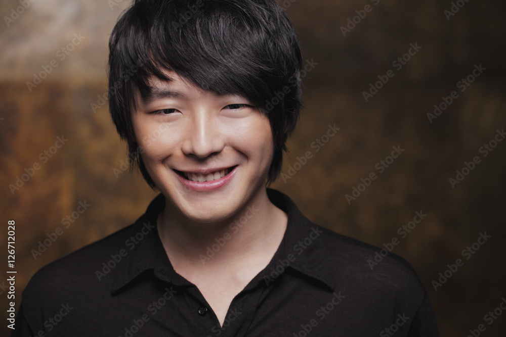 Head shot of young man smiling at camera Head shot of young man smiling at camera