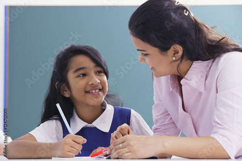 teacher and student smile at each other