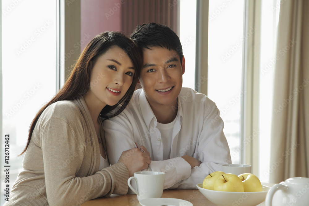 Young couple sitting together in their home Young couple sitting together in their home