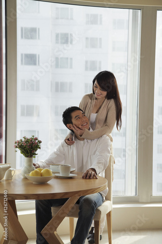 Young couple smiling at each other in their condo