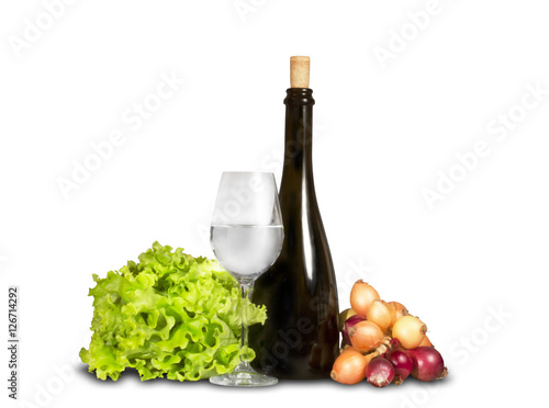 Group of vegetable greenery with water glass and bottle