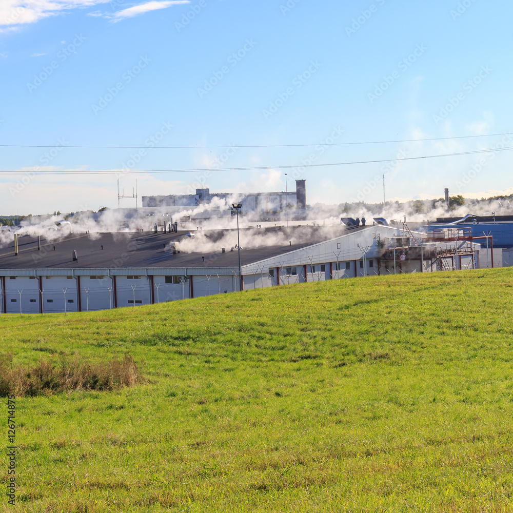 Obraz premium Factory production buildings roof with steam 