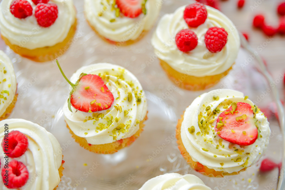 Delicious cupcakes with berries close up