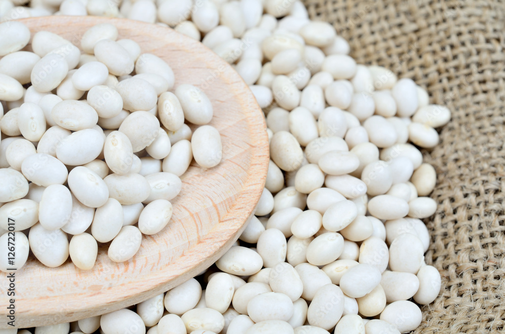 white beans on wooden spoon white beans on wooden spoon