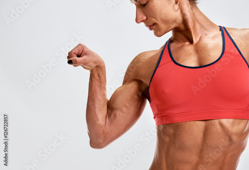 part of Woman bodybuilder showing biceps