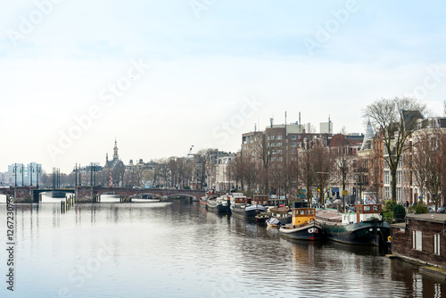 Beautiful view of Amsterdam canals with bridge and typical dutch © ilolab