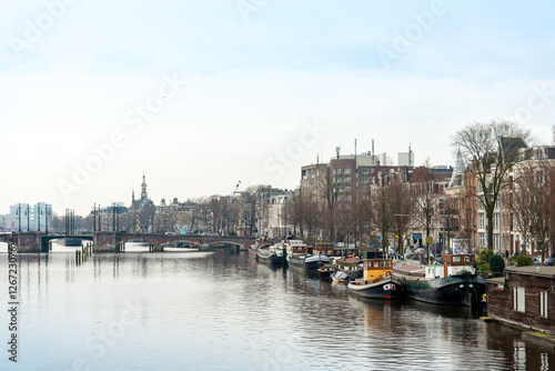 Beautiful view of Amsterdam canals with bridge and typical dutch