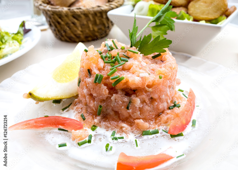 salmon and lemon - french cuisine dish with tomato and salmon