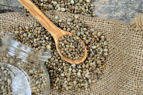 hemp seed on table with spoon and jar