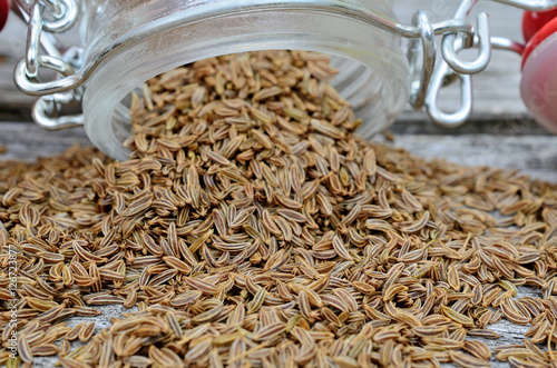 caraway in jar flow on table photo