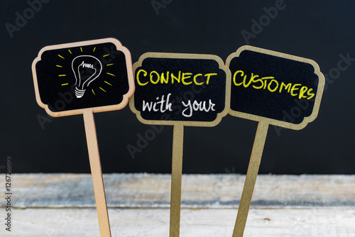 Concept message CONNECT WITH YOUR CUSTOMERS and light bulb as symbol for idea