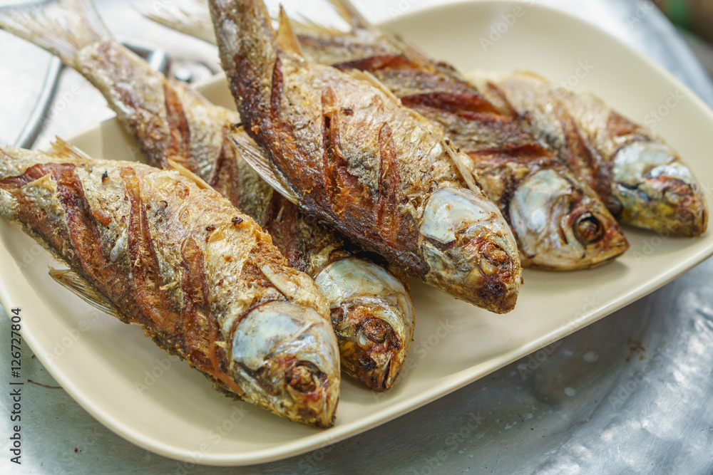 Fried fish on the disk with sun soft light Fried fish on the disk with sun soft light
