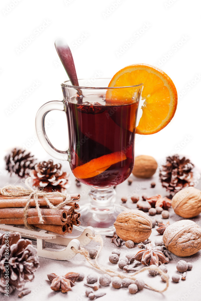 One glass of hot mulled wine and a slice of orange, spices, pine One glass of hot mulled wine and a slice of orange, spices, pine