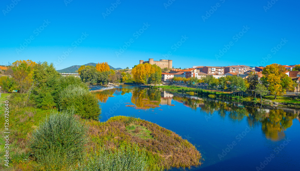 Castle along a river in sunlight