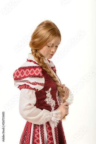beautiful red-haired girl in the national costume. Belarus