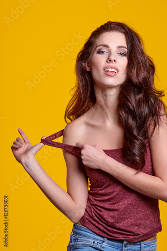 Young sensual girl in fashion clothes pose in studio