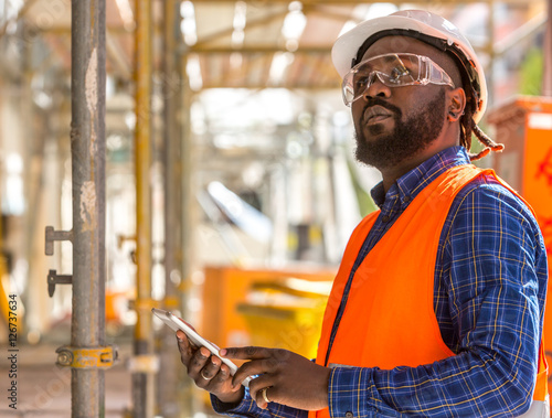 Attractive African american engineer at work on construction site photo
