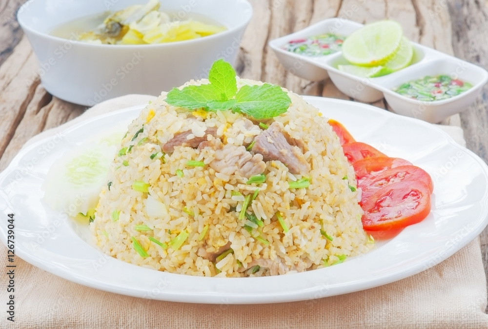 Fried rice with chili sauce and soup on wooden table Fried rice with chili sauce and soup on wooden table