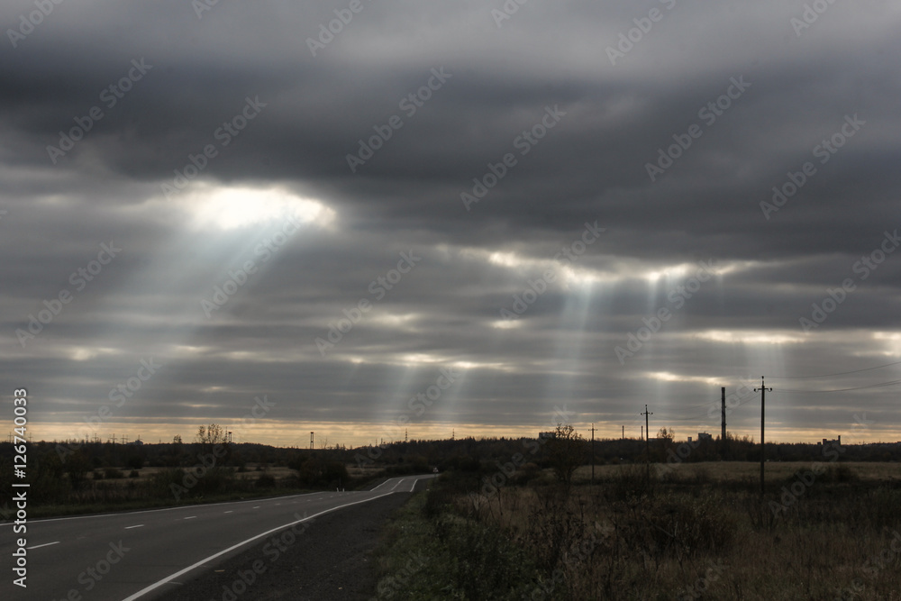 The sun's rays through the clouds.
