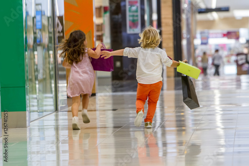 Kids shopping. cute little girl and boy on shopping. portrait of