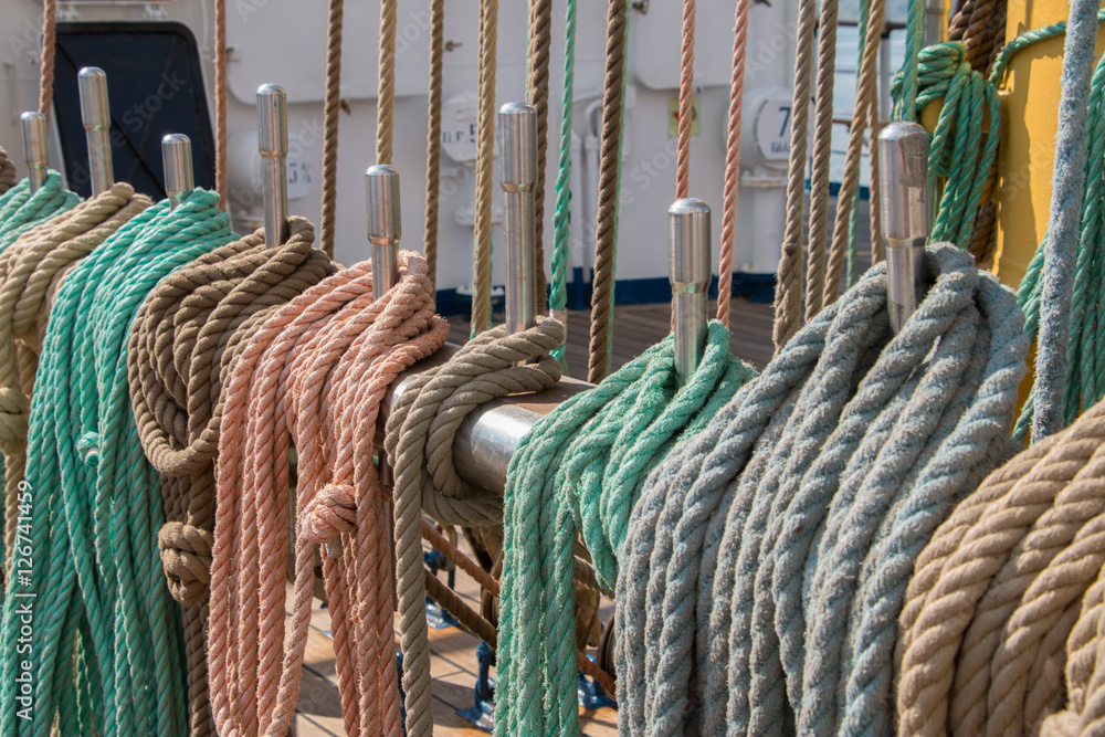 Deck and ropes, rigging on a wooden tall ship sail yacht. Close up view